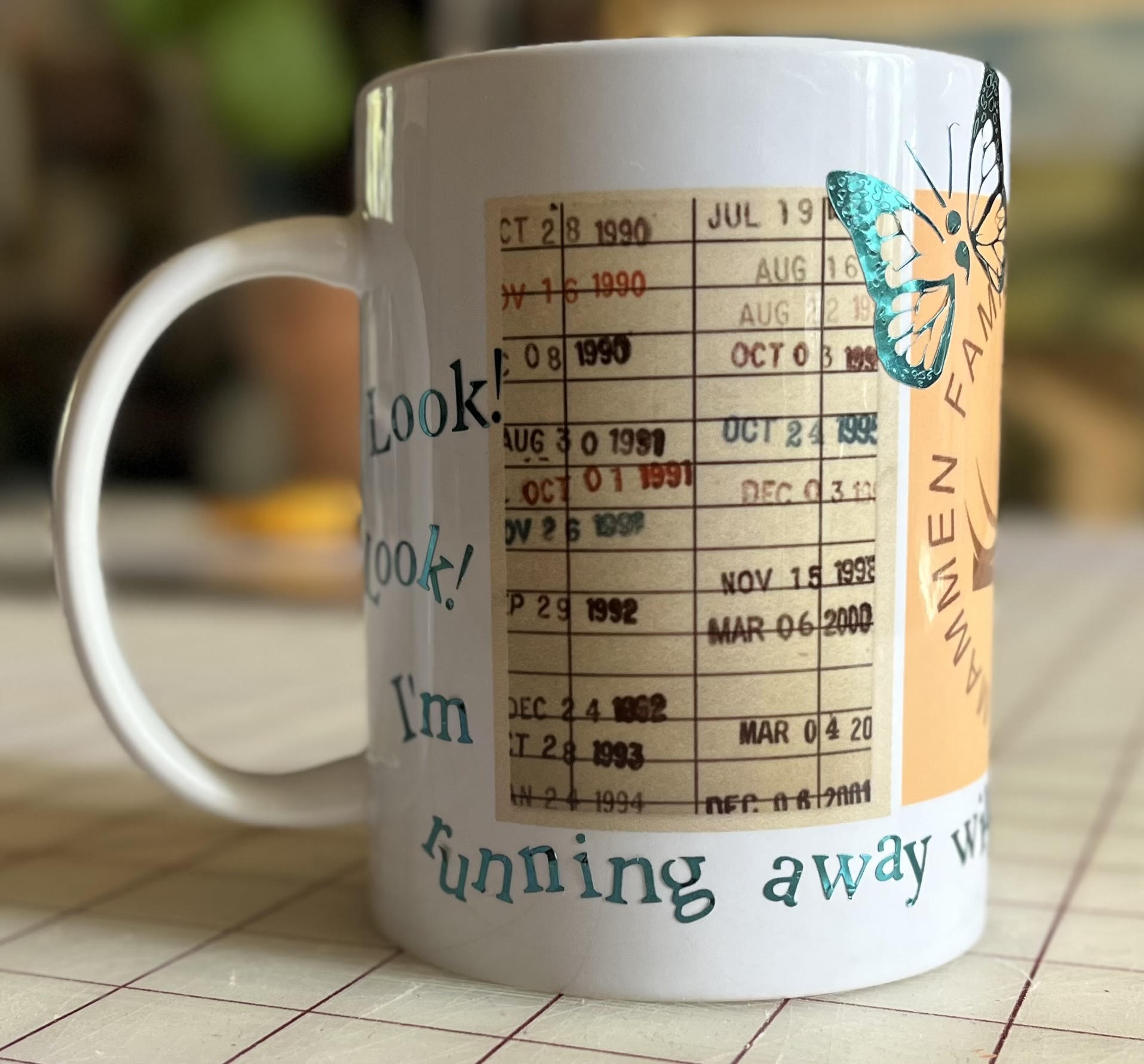 White mug with vintage library card graphic