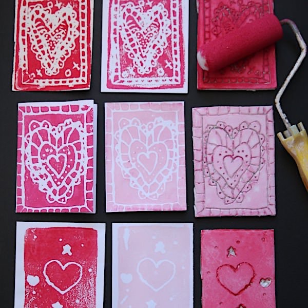 Image of pink and red printed hearts and a brayer for rolling ink