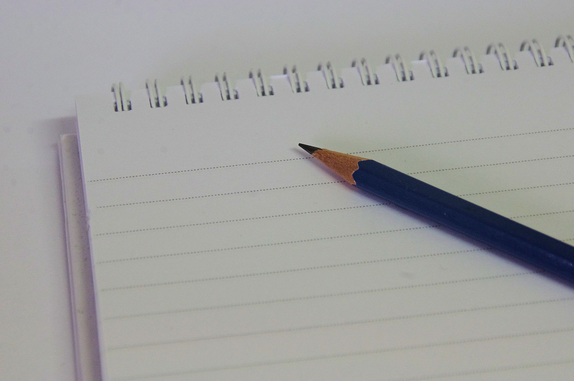 close up photo of a pencil and notebook