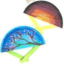 Paper plates attached to popsicle sticks to make fans
