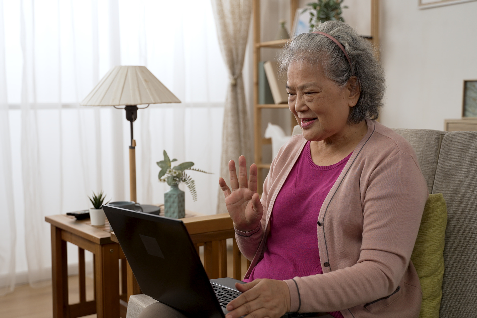 An older woman using a laptop