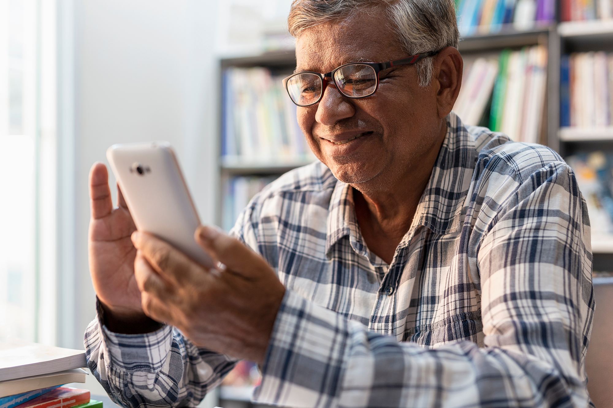 An older gentleman using a smartphone