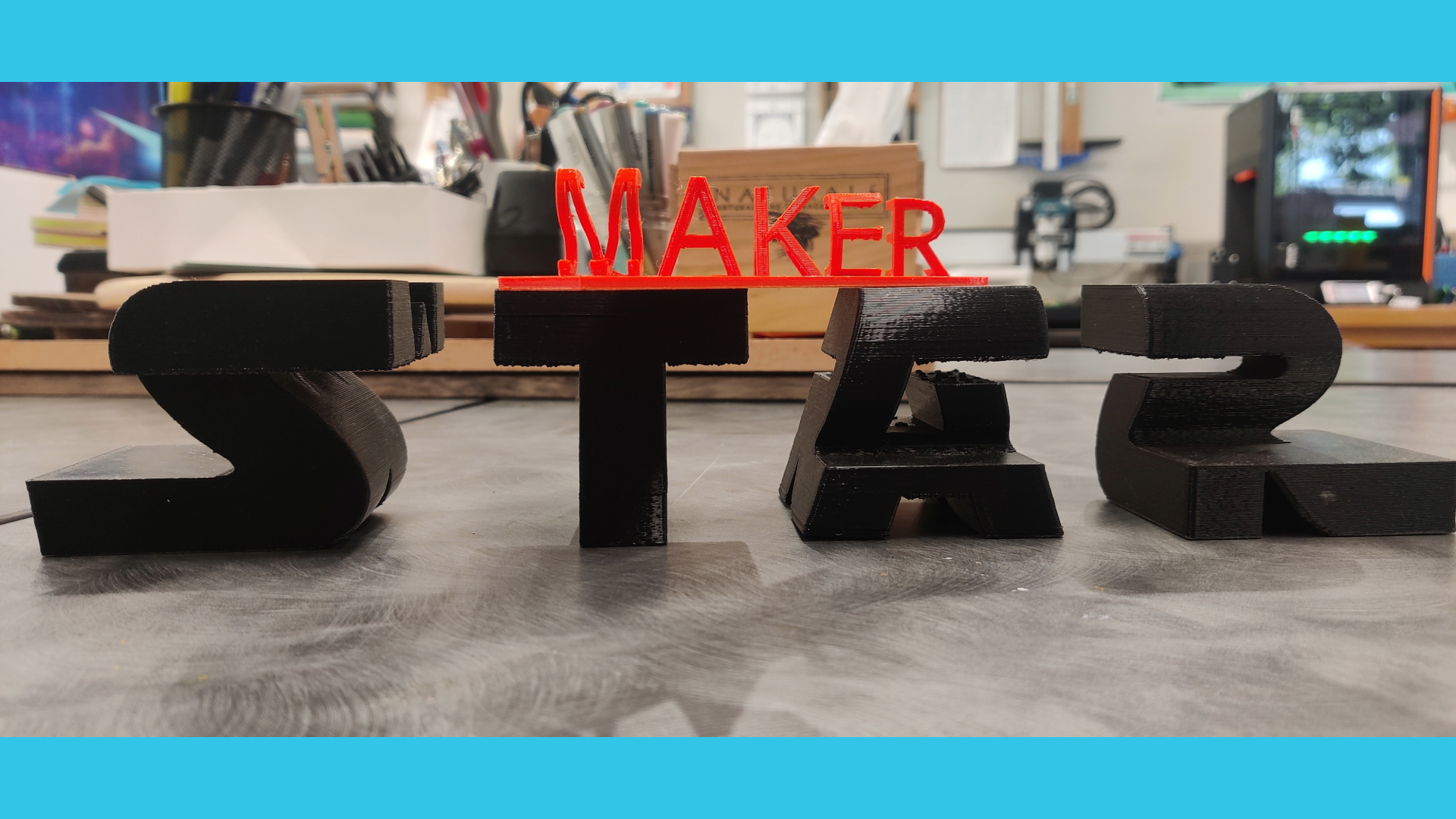 3D print of "Flip-Text", one side reading *Maker and the otherside reading *Space, printed at the Mammen Family Public Library's Makerspace