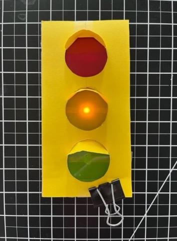 Picture of paper stoplight with illuminated yellow light