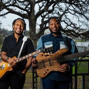 The Peterson Brothers holding guitars