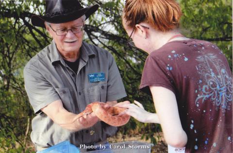 tom holding a snake