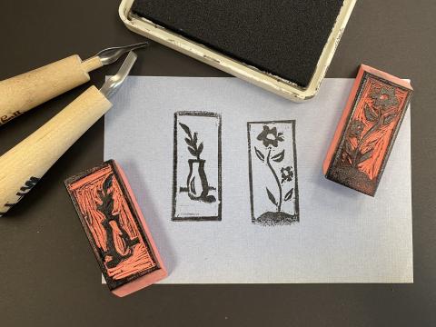 Two floral inspired stamps created by carving a pink school eraser