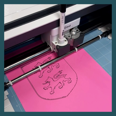 Cricut machine "drawing" an family crest