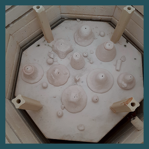 ceramic bells inside a kiln
